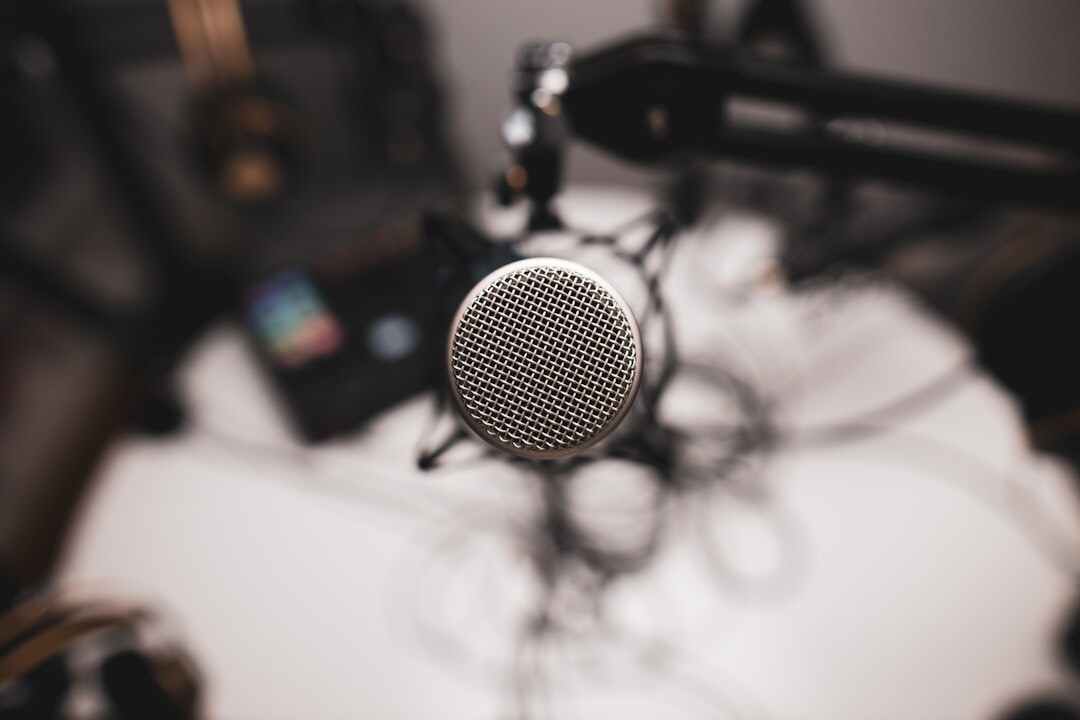 Podcast microphone with pop filter on a desk